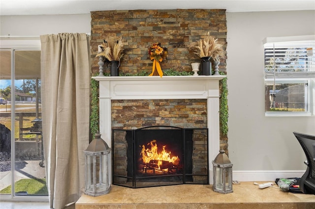 interior details with a stone fireplace