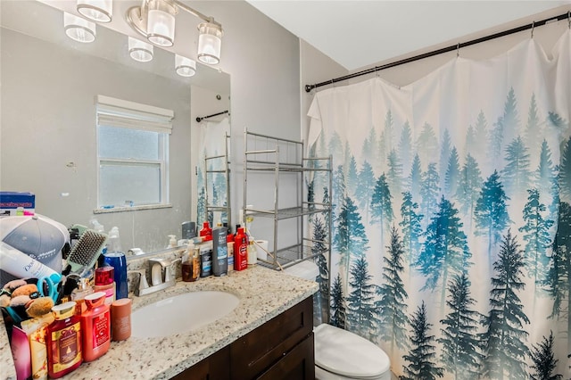 bathroom with toilet, curtained shower, and vanity