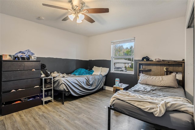 bedroom with ceiling fan and light wood-type flooring