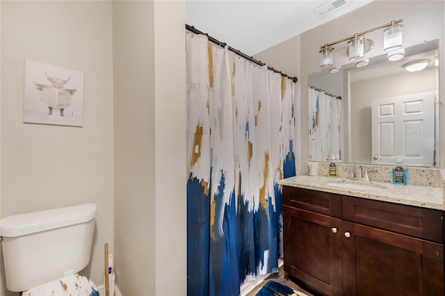 bathroom with toilet and vanity