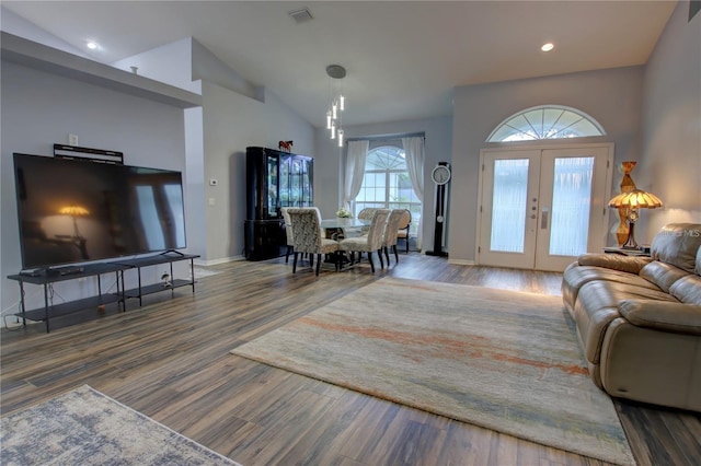 living room featuring french doors, hardwood / wood-style flooring, and vaulted ceiling