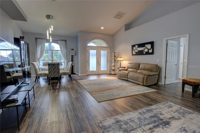 living room with lofted ceiling, french doors, and dark hardwood / wood-style floors