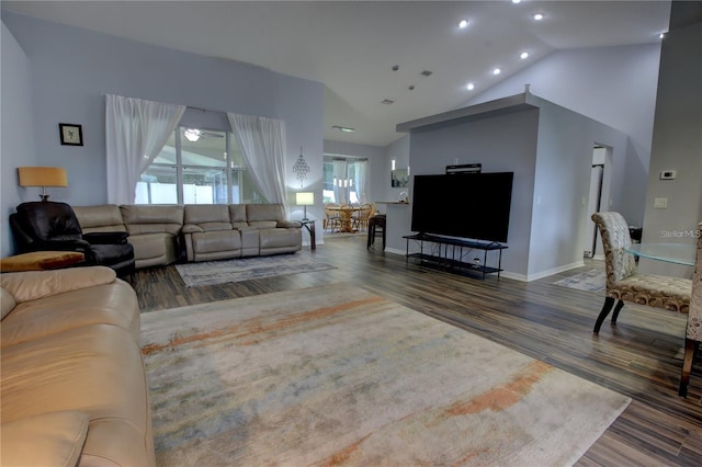 living room featuring hardwood / wood-style flooring, high vaulted ceiling, and ceiling fan