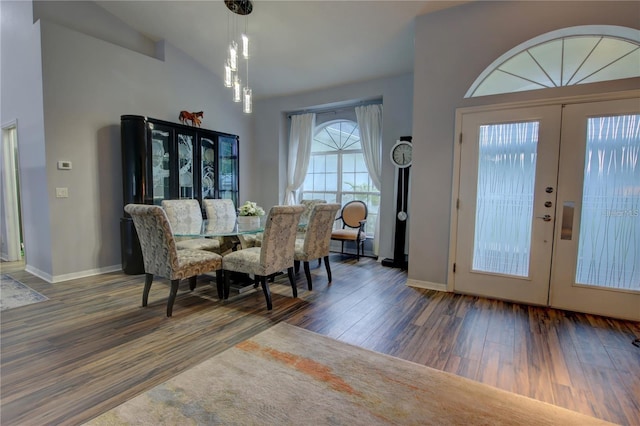 dining room featuring lofted ceiling, french doors, and dark wood-type flooring