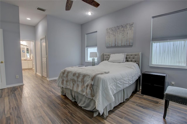 bedroom featuring ceiling fan, dark wood-type flooring, and connected bathroom