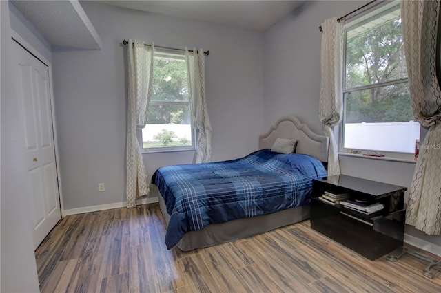 bedroom with dark wood-type flooring