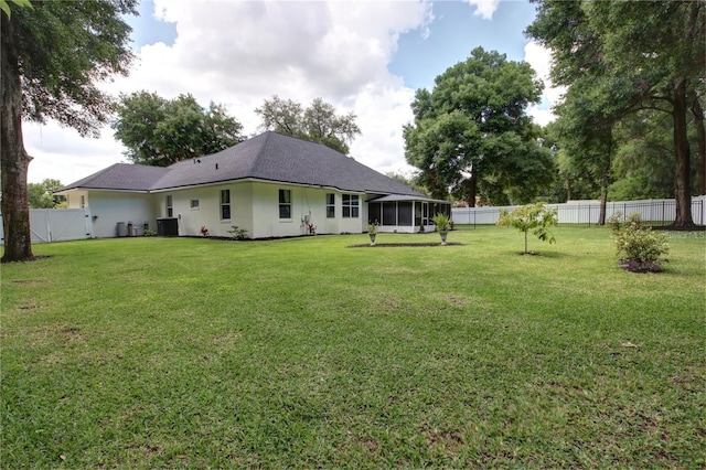 view of yard featuring central AC unit and a sunroom