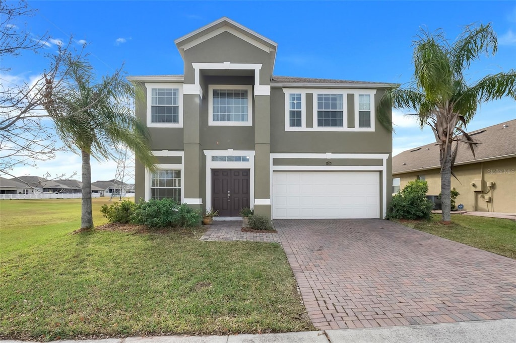 view of front of property featuring a front lawn and a garage