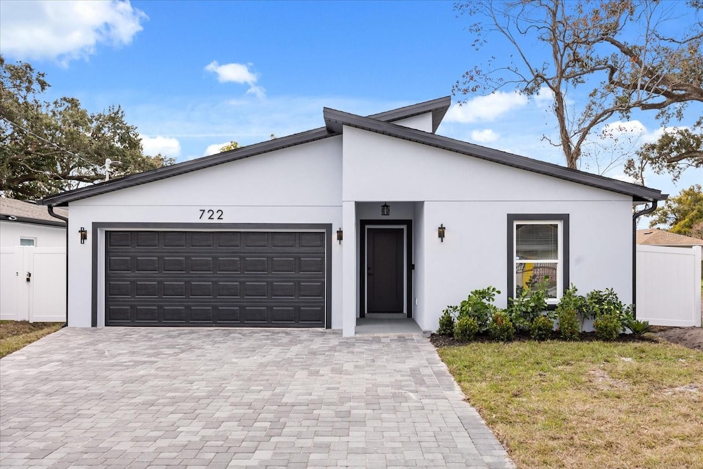 view of front of home featuring a garage and a front lawn