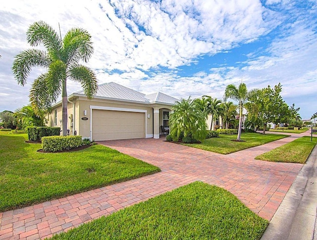 single story home with a garage and a front yard