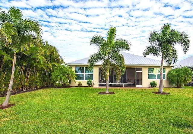 exterior space with a front lawn and a sunroom