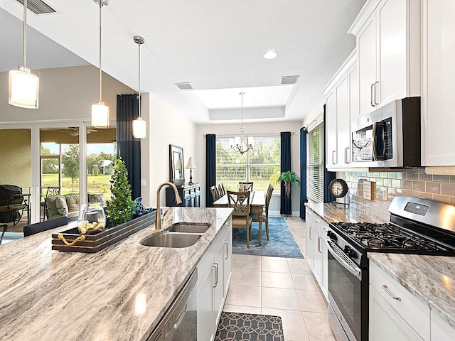 kitchen featuring stainless steel appliances, sink, and white cabinets