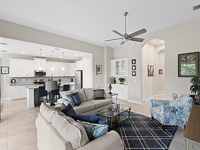 tiled living room featuring ceiling fan