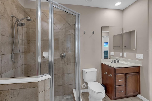 bathroom with walk in shower, vanity, tile patterned floors, and toilet