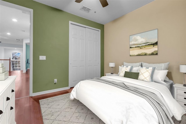 bedroom featuring a closet, dark hardwood / wood-style flooring, and ceiling fan