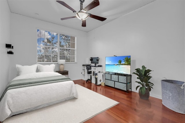 bedroom with ceiling fan and dark hardwood / wood-style flooring