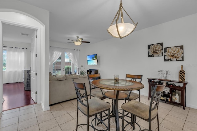 tiled dining area with ceiling fan