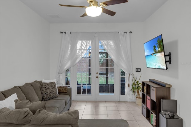 tiled living room with ceiling fan and french doors