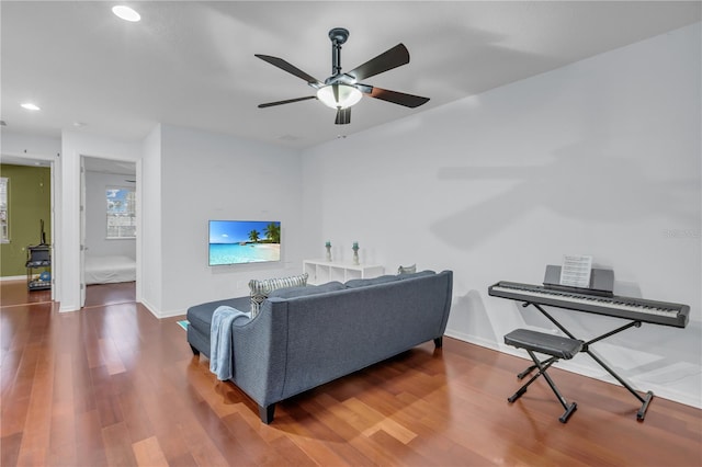 living room featuring ceiling fan and hardwood / wood-style floors