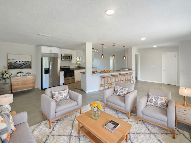 living room featuring tile patterned flooring and a textured ceiling