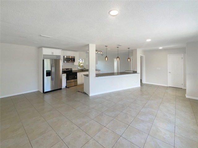 kitchen with stainless steel appliances, hanging light fixtures, kitchen peninsula, white cabinetry, and light tile patterned flooring