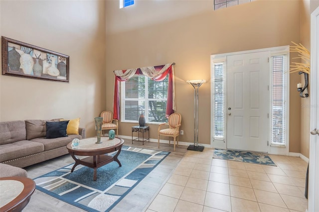 entryway featuring a high ceiling and light tile patterned floors