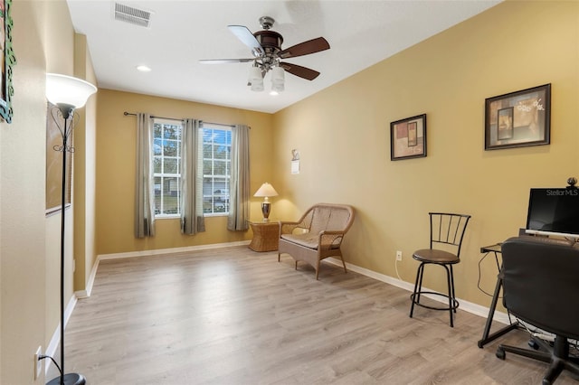 sitting room with ceiling fan and light hardwood / wood-style flooring