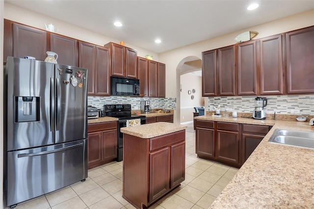 kitchen with black appliances, tasteful backsplash, sink, and light tile patterned floors