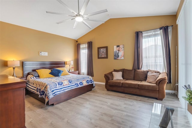 bedroom with vaulted ceiling, ceiling fan, and light hardwood / wood-style floors