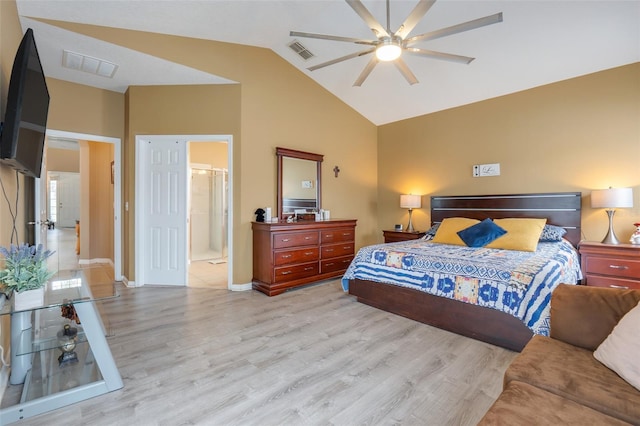 bedroom with high vaulted ceiling, ceiling fan, light hardwood / wood-style flooring, and connected bathroom