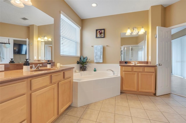 bathroom with independent shower and bath, vanity, and tile patterned floors