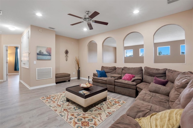 living room featuring ceiling fan and light hardwood / wood-style floors