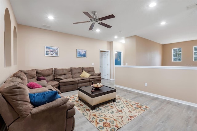 living room featuring ceiling fan and light hardwood / wood-style floors