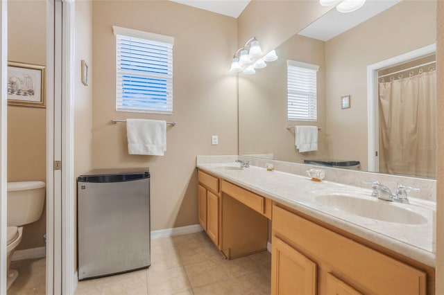 bathroom featuring toilet, vanity, and tile patterned floors