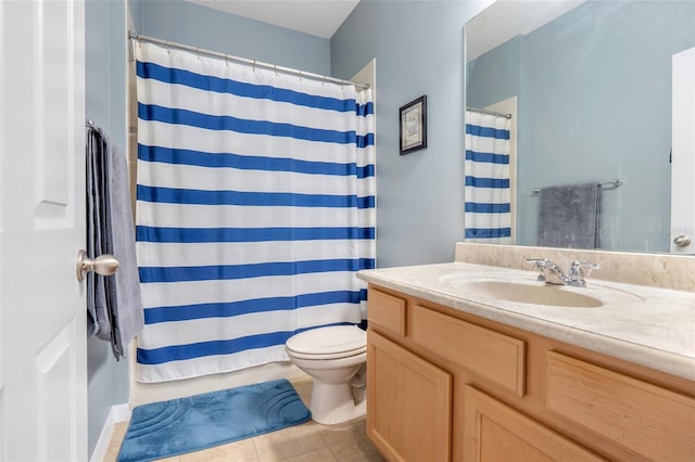 bathroom with toilet, tile patterned flooring, and vanity