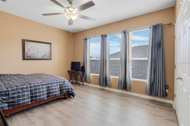 bedroom with ceiling fan and light wood-type flooring