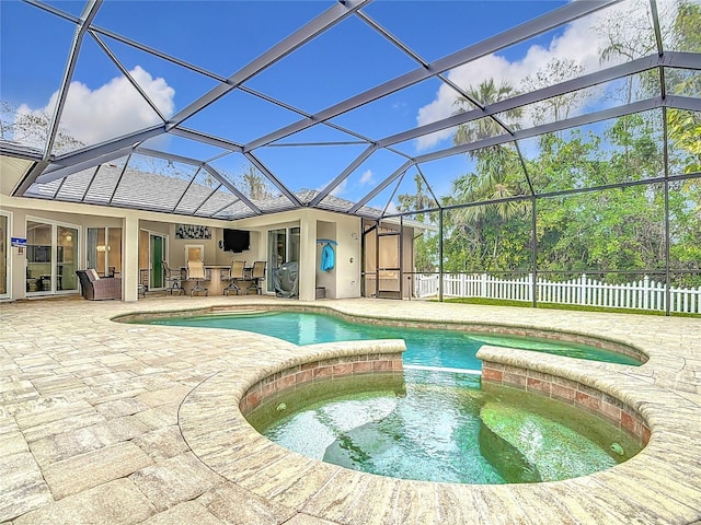 view of swimming pool featuring glass enclosure, a patio, an in ground hot tub, and a bar