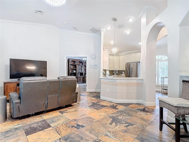 living room with sink and ornamental molding