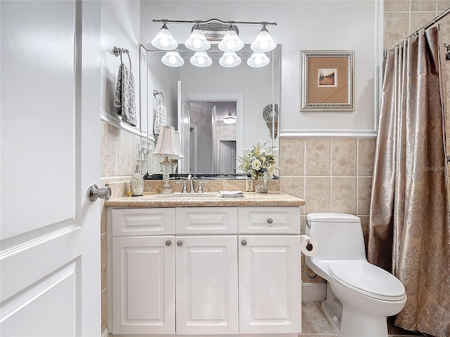 bathroom featuring tile walls, toilet, and vanity