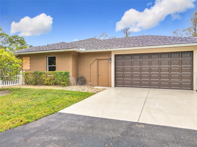 view of front of house featuring a garage and a front yard