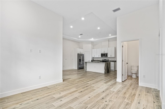 unfurnished living room featuring sink