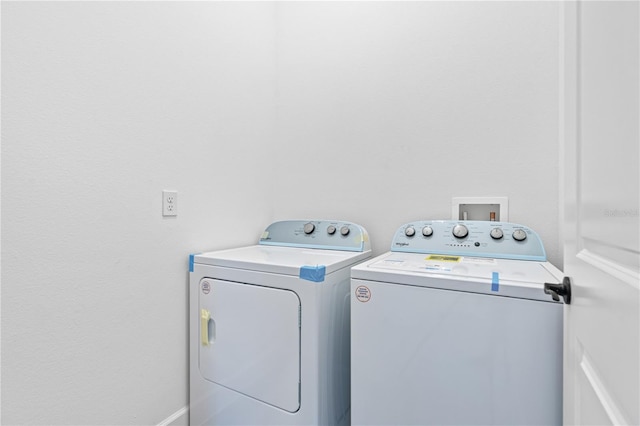 clothes washing area featuring independent washer and dryer