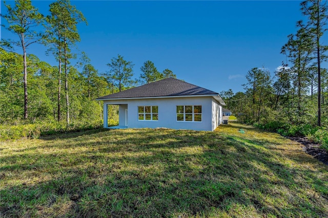 view of side of property with a lawn