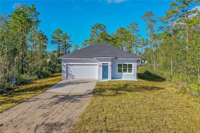 view of front of home with a front yard and a garage