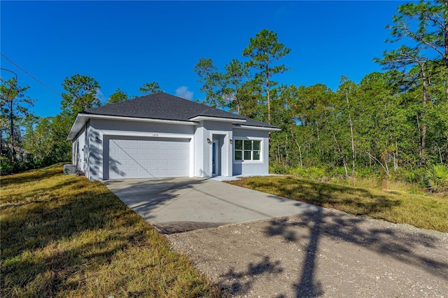 view of front facade featuring a front yard and a garage