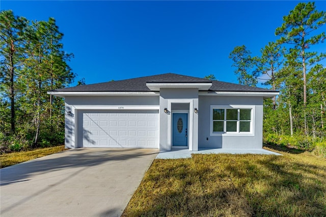 view of front of house with a front yard and a garage