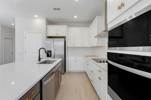 kitchen featuring light stone counters, visible vents, decorative backsplash, appliances with stainless steel finishes, and white cabinetry