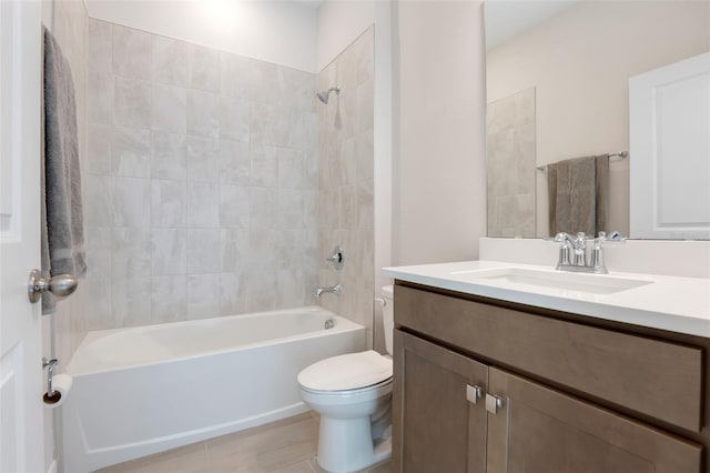 bathroom featuring toilet, vanity, and shower / bathing tub combination