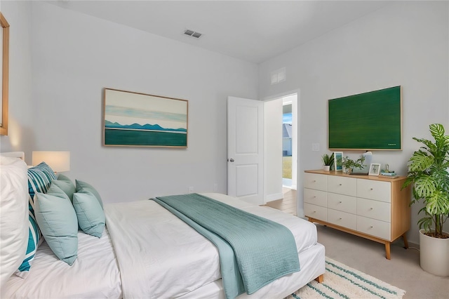 bedroom featuring visible vents and light colored carpet