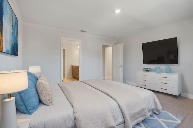 bedroom featuring baseboards, connected bathroom, visible vents, and light colored carpet